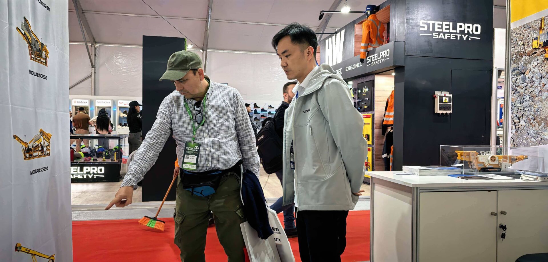 South American customers interested in mobile crushing equipment Potential clients discussing mobile crushers at the Midas booth